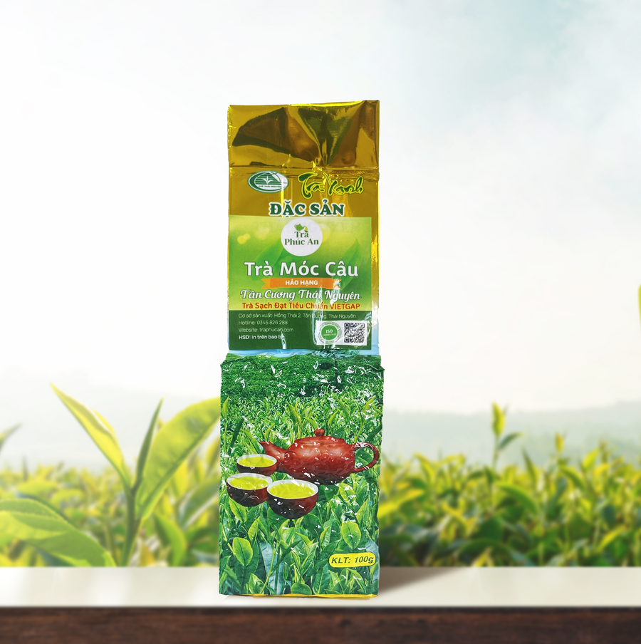 Gói Trà Móc Câu Hảo Hạng 100g màu xanh và vàng, in hình ấm đỏ cùng các chén trà.
